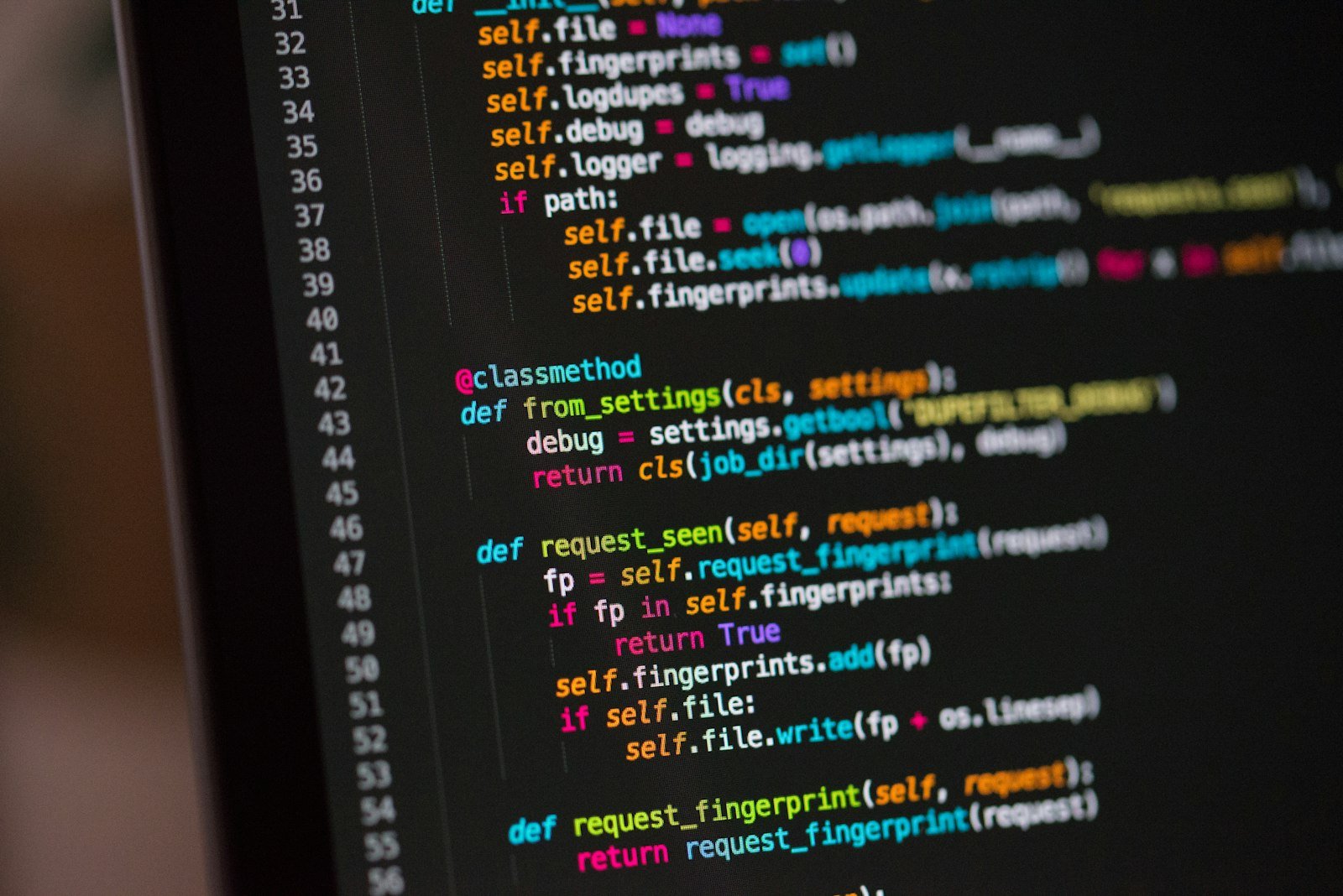 Laptop showing code in a dark editor used for a Claude Code beginner tutorial