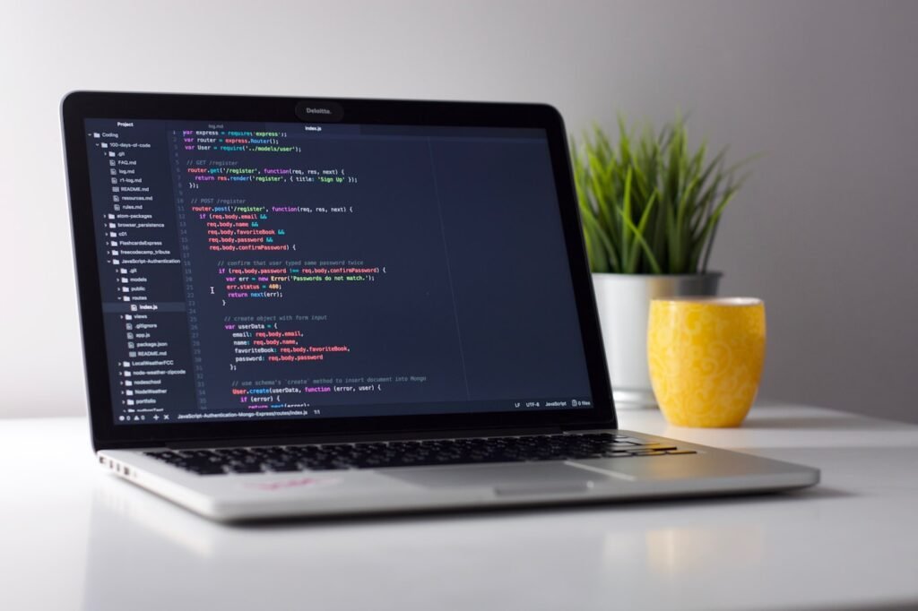 Developer reviewing AI-generated code on a laptop with a checklist notebook nearby