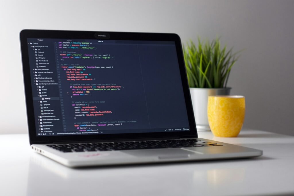 Developer building an app in a browser-based AI coding workspace on a laptop