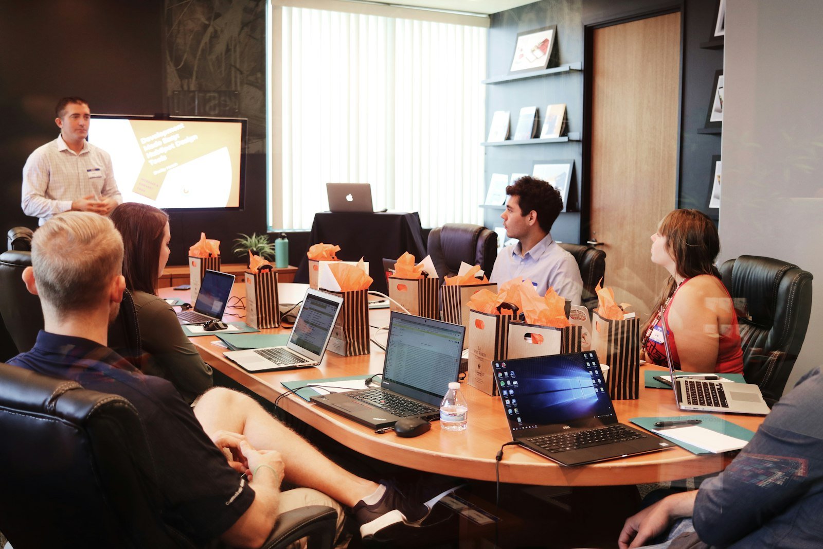 Team around a table reviewing a prototype for Figma motion handoff to engineers