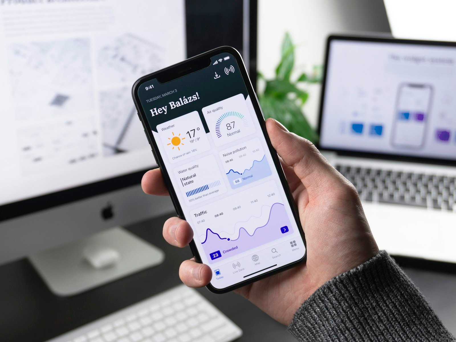 Mobile app screens on a phone representing Smart Animate to production handoff