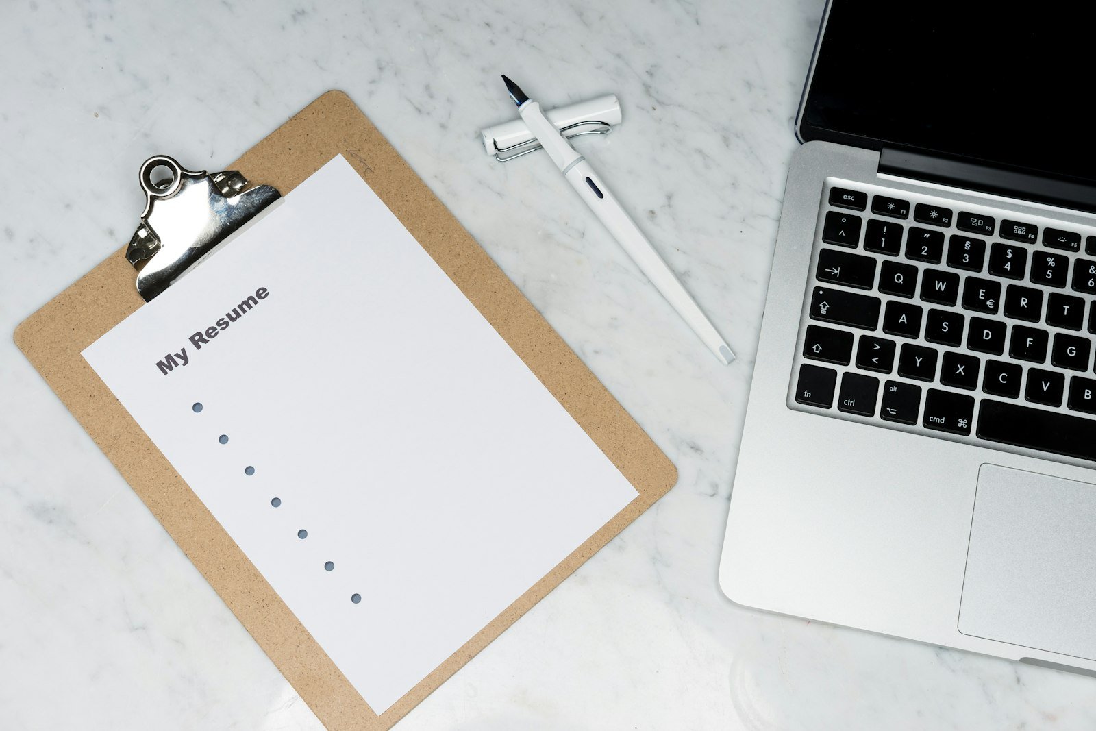Notebook with UI wireframe checklist for landing page dashboard and settings prompts